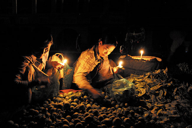 Warzywny  targ w Sittwe o wicie, gdzie kupujcy wybieraj towar przy blasku wiec. Canon EOS 50D + Canon 17–85 mm; 1/6 s; ISO 3200; f/4; f=22 mm